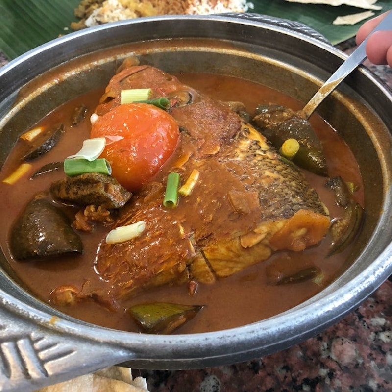 A serving of Karu's Indian Banana Leaf Restuarant’s Fish Head Curry