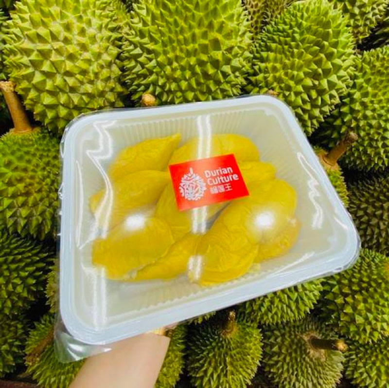 hand in frame shot of dehusked durian