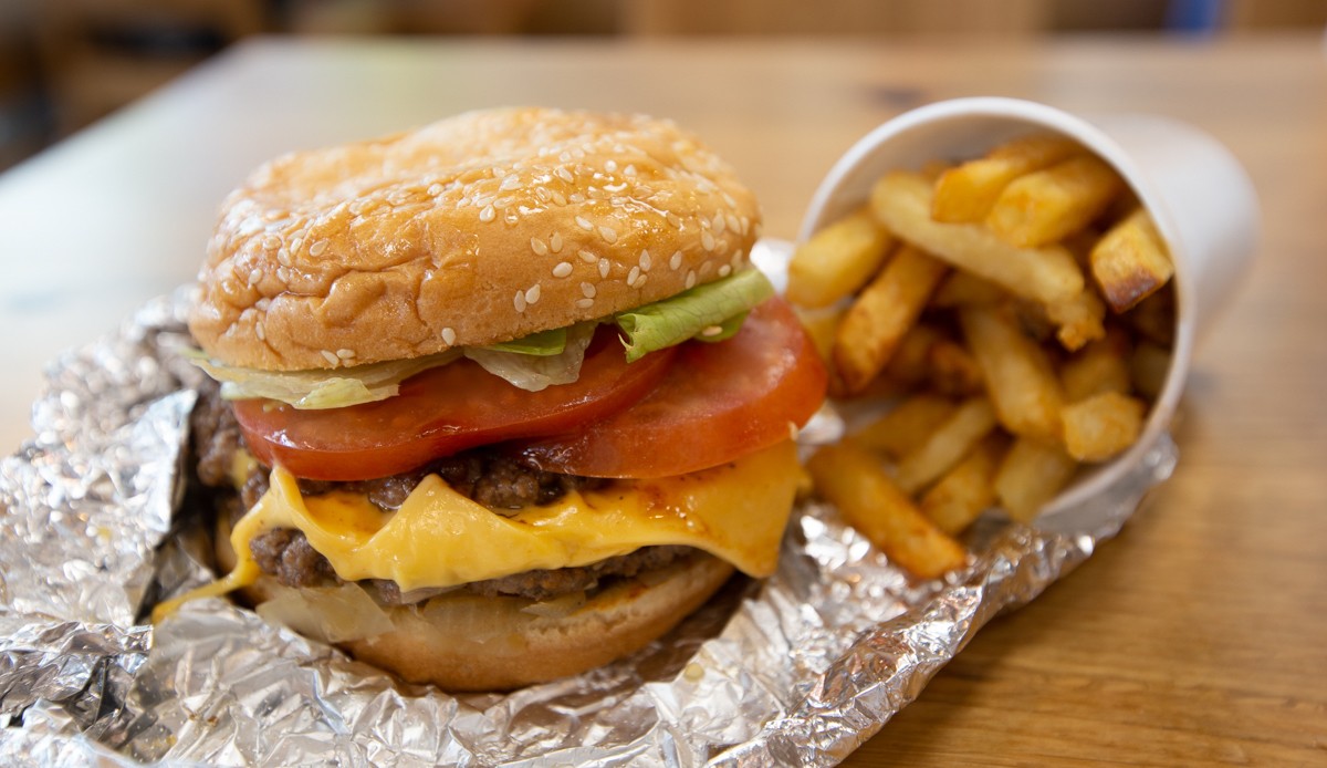 Five Guys burger on aluminum foul with side of fries