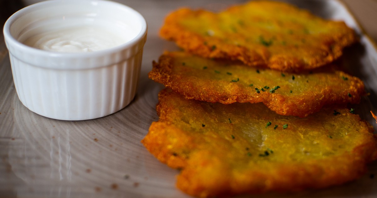 plate of potato pancakes with sour cream