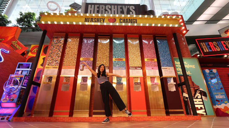 Picture of girl standing infront of HERSHEY’S amazing giant-sized world of chocolate