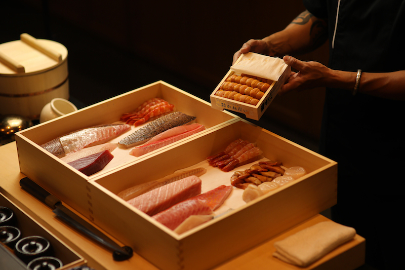 A picture with a box of fresh japanese imported fishes