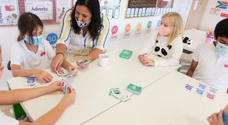 A group of children and adults playing bye bye virus