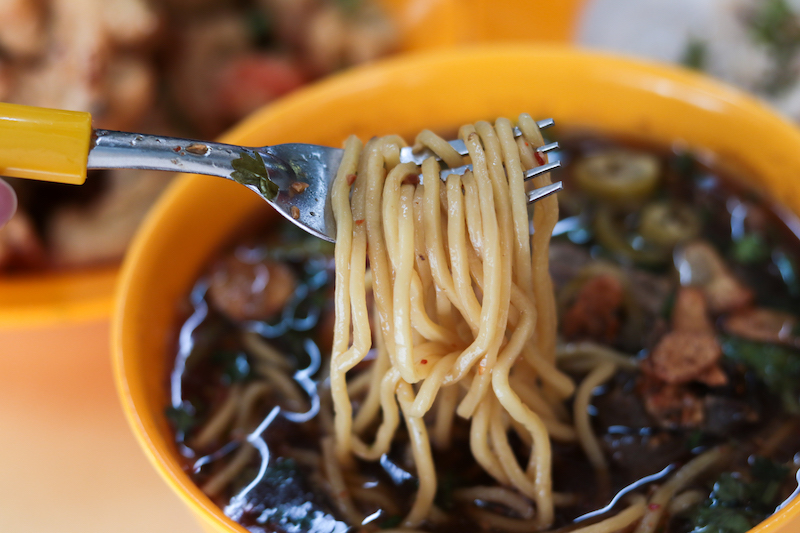 Close up of yellow noodles in Kelate's Mee Celup