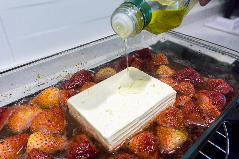 Drizzling olive oil on feta cheese