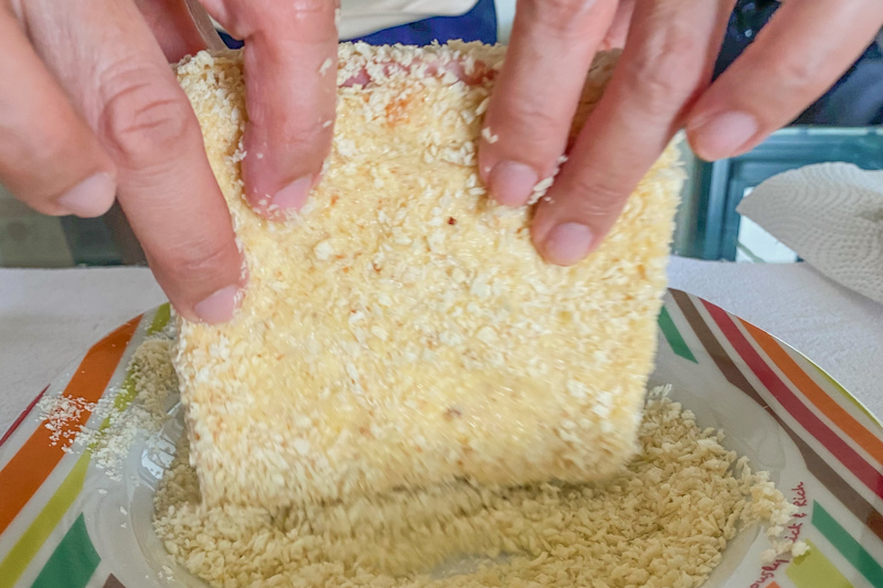 Step 5: Picture of sandwich being coated with breadcrumbs 