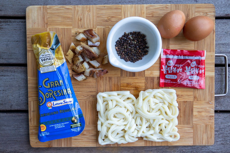 Flatlay of all the ingredients for spicy udon carbonara