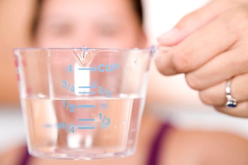 Woman using a liquid measuring cup