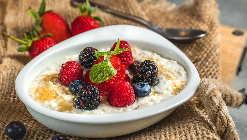 A bowl of oats with an array of berries