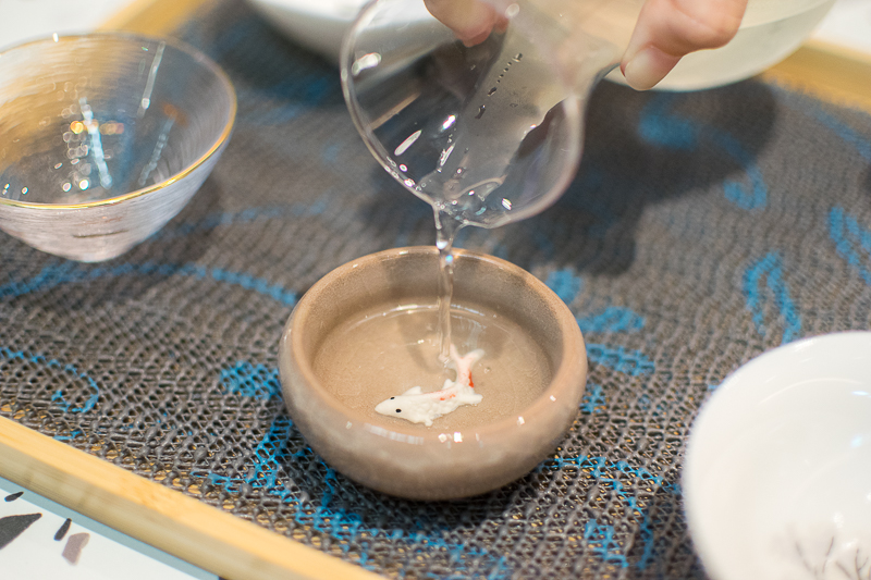A pouring shot of sake
