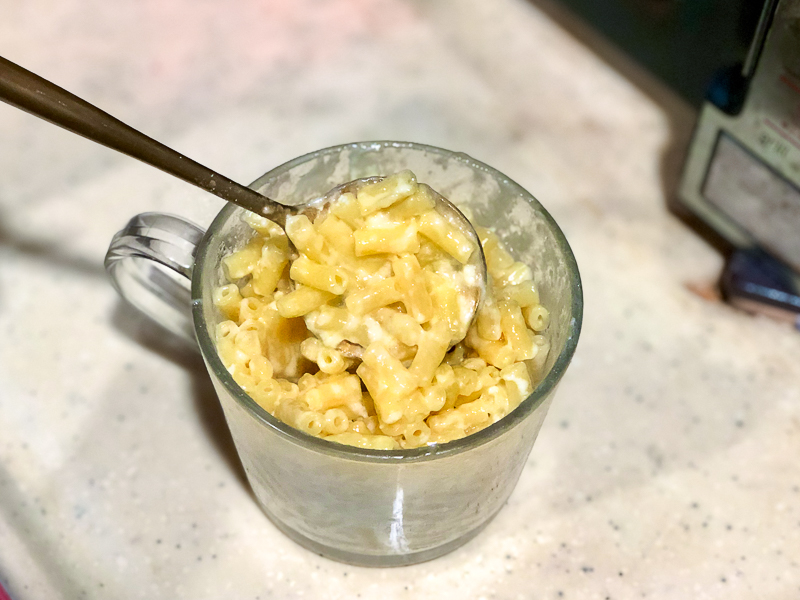 A scooping shot of mac & cheese