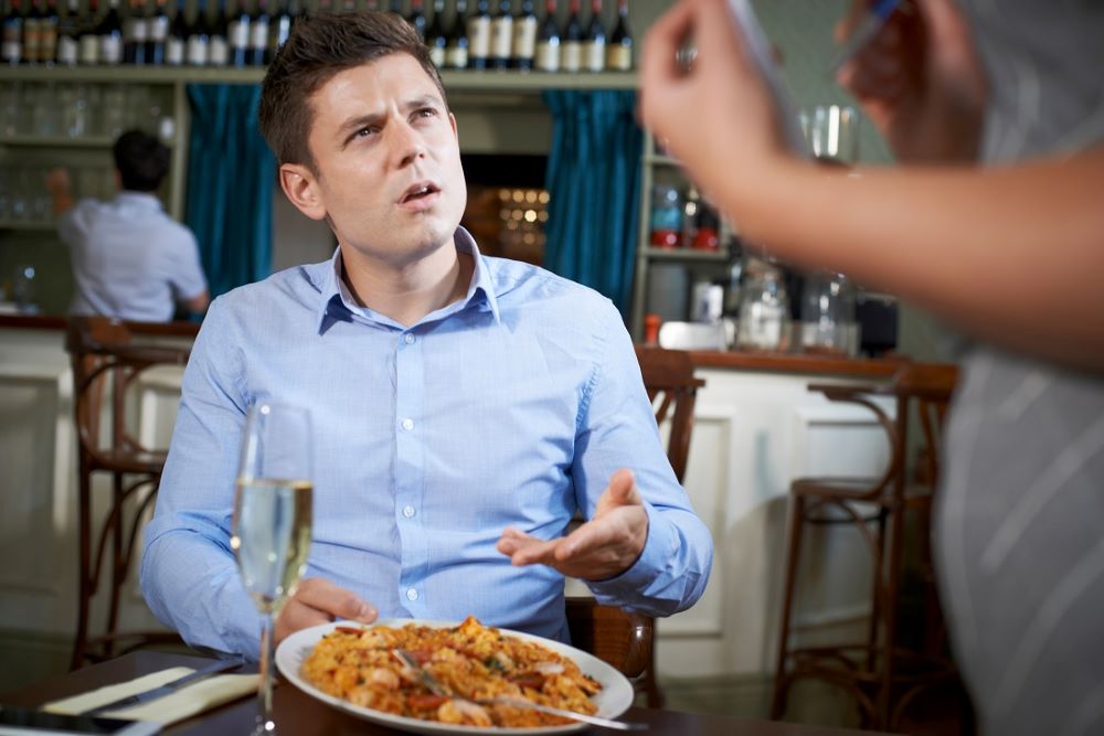 Man giving feedback about food to wait staff