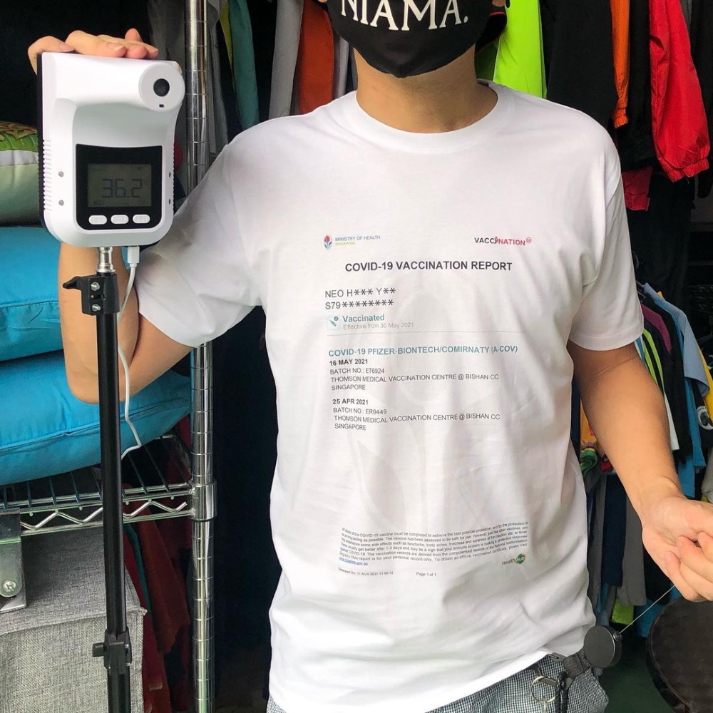 Man with vaccination report on T-shirt