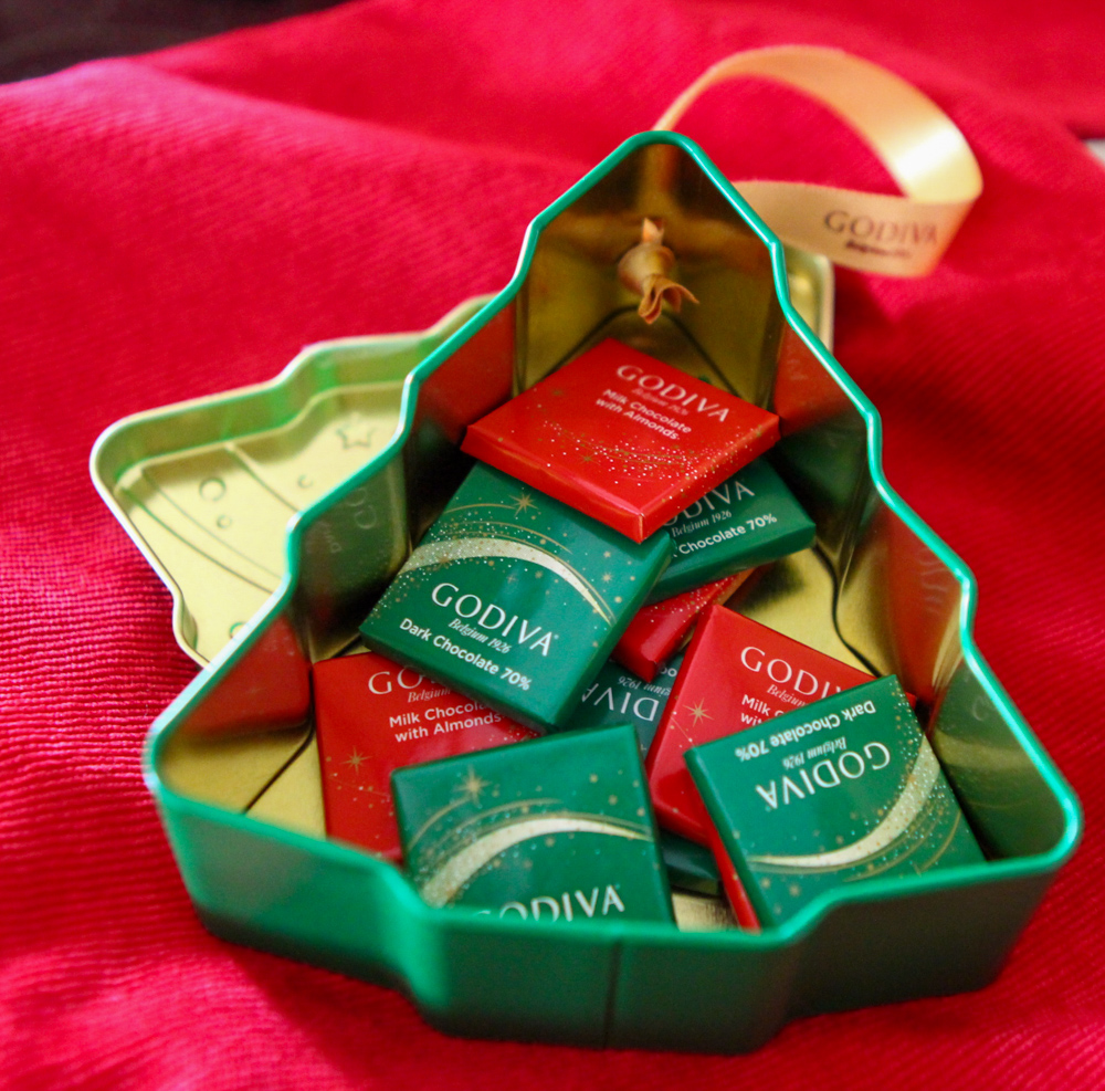 Close up of GODIVA chocolates in holiday tree tin