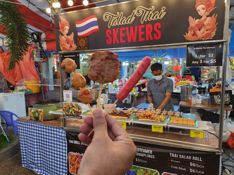 pasar malam - holding up skewers