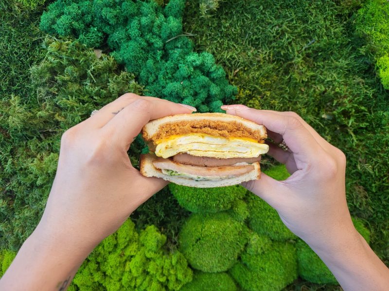 true breakfast - holding up sandwich