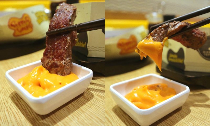 pepper lunch - steak dunking into cheese