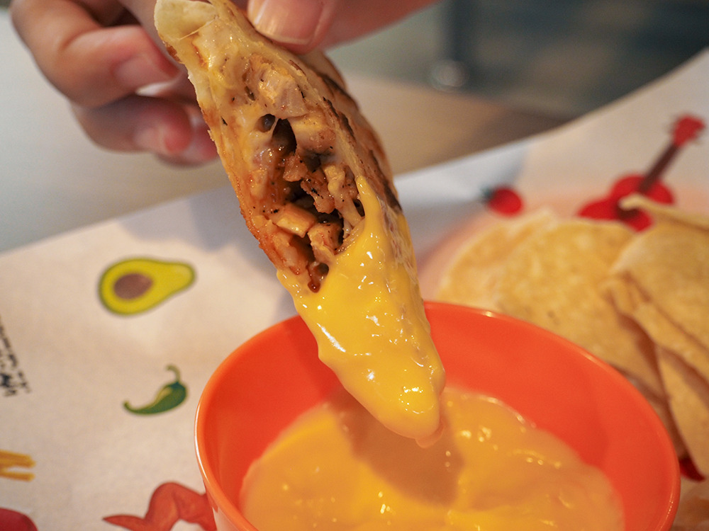 Snack That Food Up - Tandoori Chicken Quesadilla dipped in nacho cheese