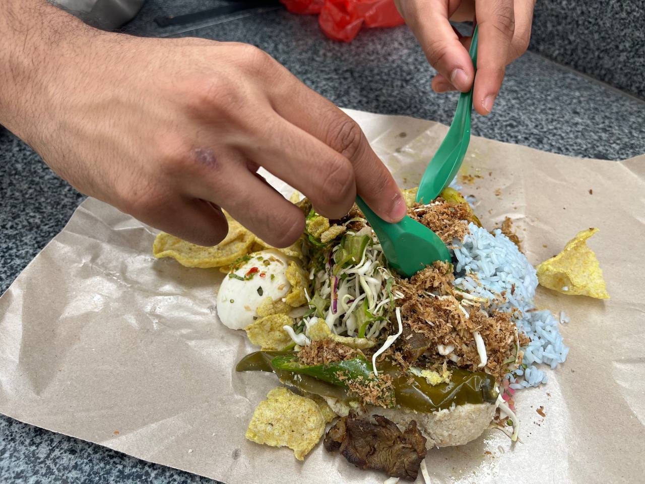 photo 6131735512566838693 y Nasi Kerabu Mek - digging into meat