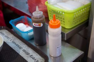 Chai Chee Pork Porridge - Pepper and soya sauce bottles