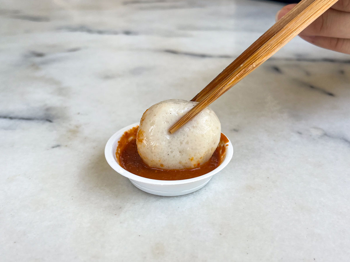 hup kee - fishball closeup dunked in chilli