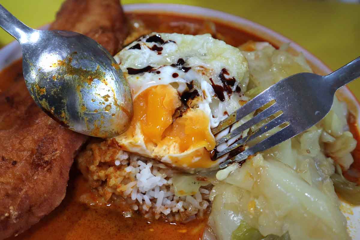 curry papa xpress - fried egg yolk closeup