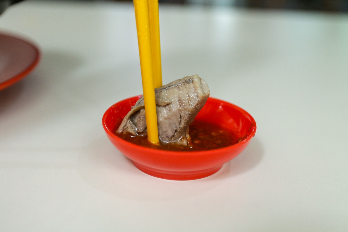 Wild Treasures Turtle Soup - dipping meat into chilli Wild Treasures Turtle Soup - dipping meat into chilli