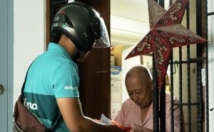deliveroo exists singapore market - image of deliveroo rider delivering parcel to resident