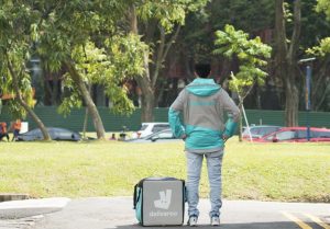 deliveroo exits singapore market - image of deliveroo rider and deliveroo bag
