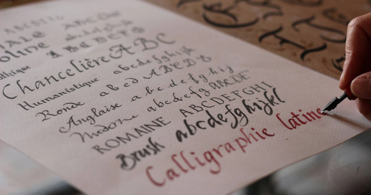 Image of a person writing in Calligraphy