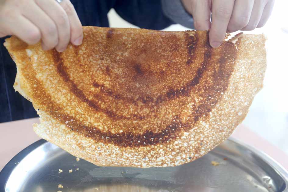 rajarani thosai newly in michelin guide - crispy cereal thosai held up