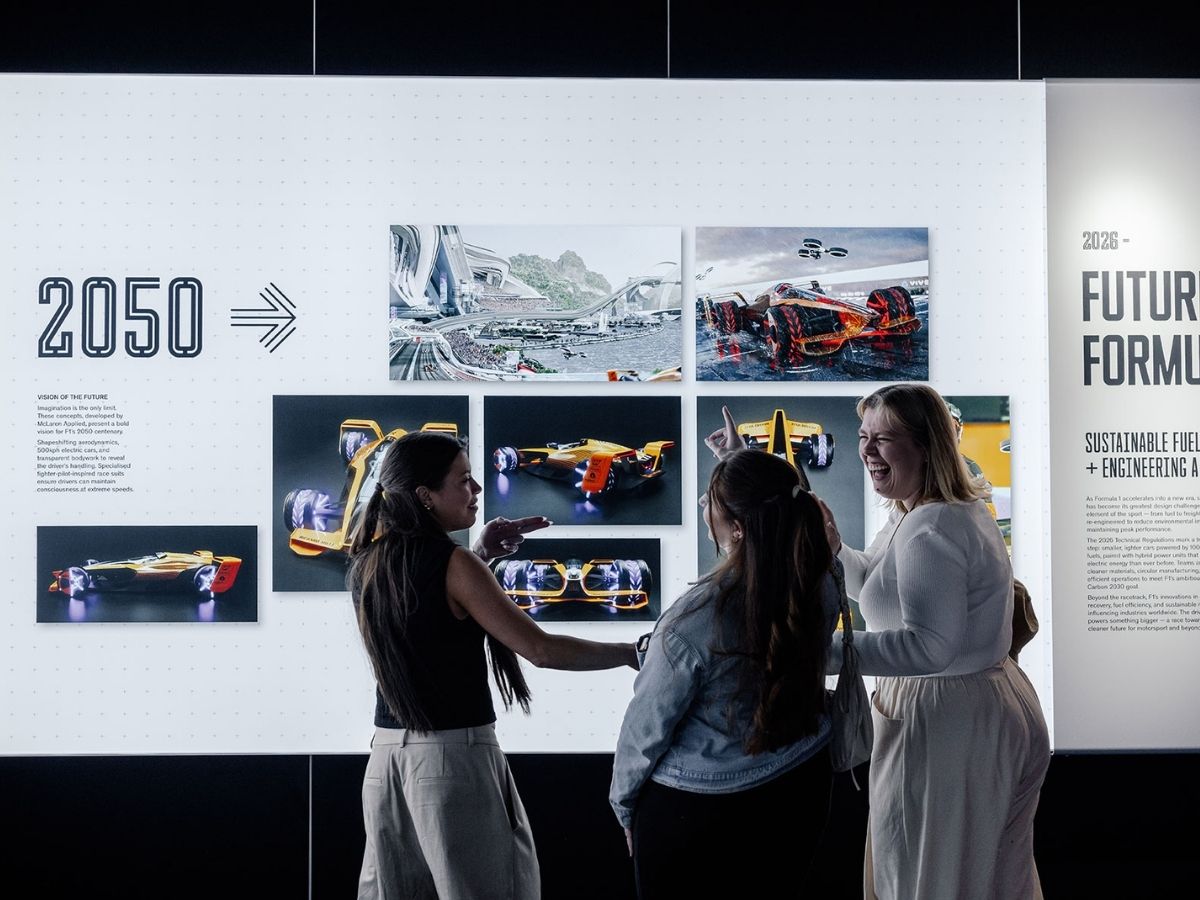 f1 exhibition - visitors looking at exhibition photos