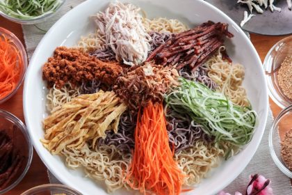 Picture of Top view of instant noodle yu sheng with condiments