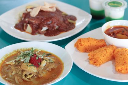 A table with three dishes from Lemaq including laksa, roti kirai and ga-do ga-do