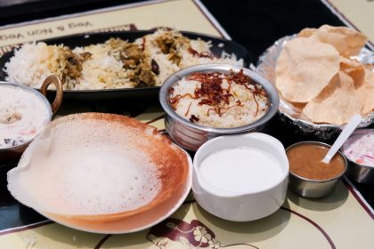 A table full of briyanis and appam at Swaadhisht