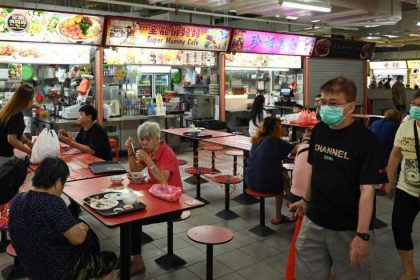 Photo of people walking in hawker centre